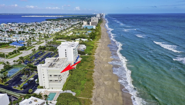 drone / aerial view featuring a water view and a view of the beach