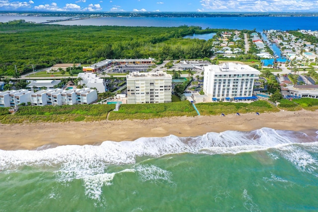 birds eye view of property featuring a view of the beach and a water view