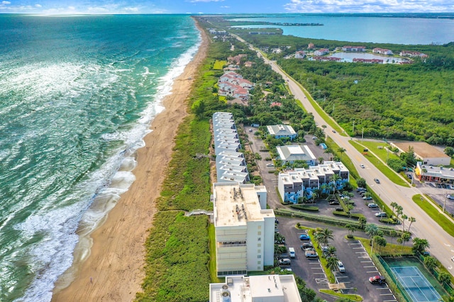 drone / aerial view featuring a water view and a beach view