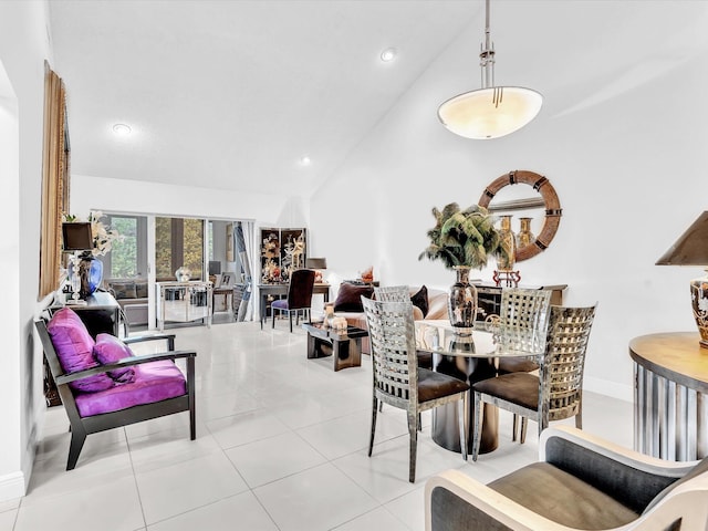 tiled dining area featuring high vaulted ceiling