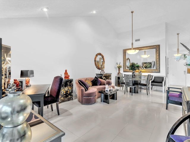 living room with high vaulted ceiling and light tile patterned floors