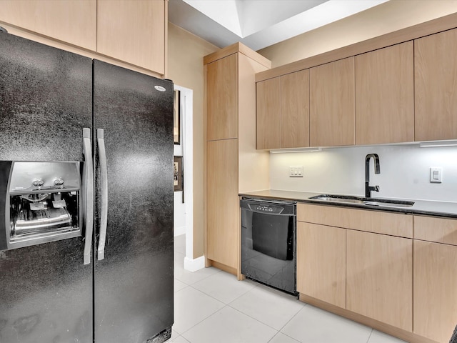 kitchen with sink, black appliances, light brown cabinets, and light tile patterned floors