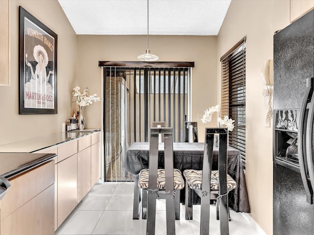 tiled dining area featuring a textured ceiling