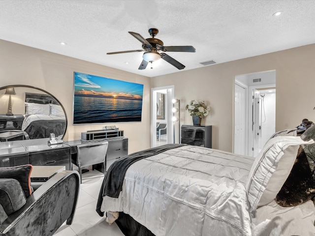 tiled bedroom featuring a textured ceiling and ceiling fan