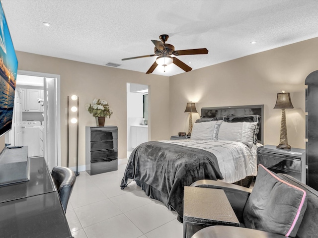 tiled bedroom with connected bathroom, washer and clothes dryer, a textured ceiling, and ceiling fan