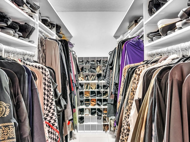 walk in closet featuring light tile patterned flooring