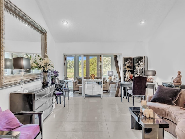 living room with light tile patterned flooring and vaulted ceiling