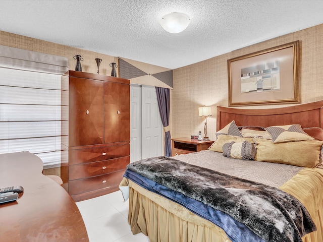 tiled bedroom with a textured ceiling