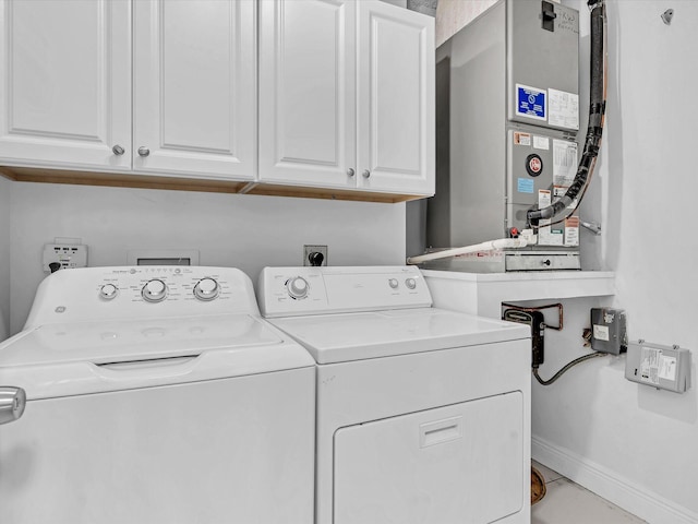 washroom featuring cabinets and independent washer and dryer