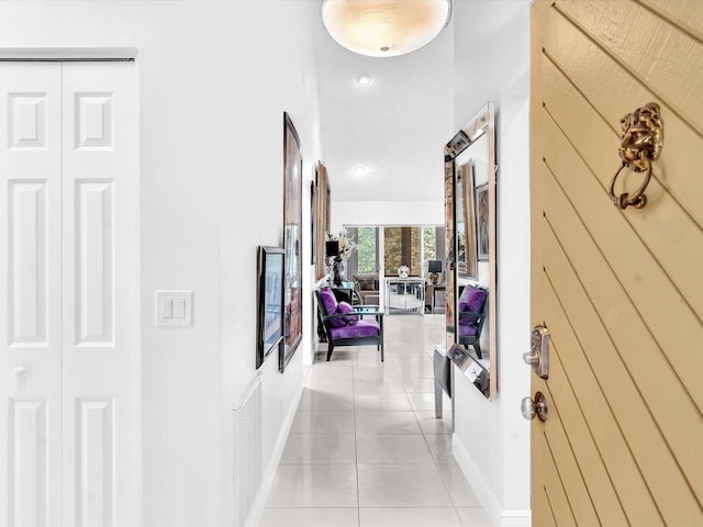 hall with light tile patterned floors