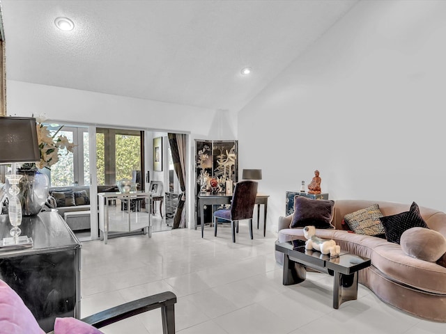 living room featuring light tile patterned floors, a textured ceiling, and vaulted ceiling