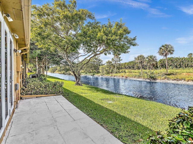 view of yard with a patio area and a water view