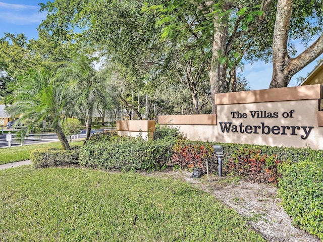 community / neighborhood sign with a yard