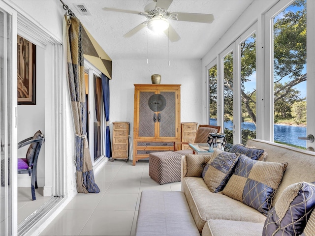 interior space featuring a water view and ceiling fan