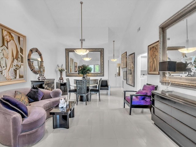 living room with high vaulted ceiling and light tile patterned floors