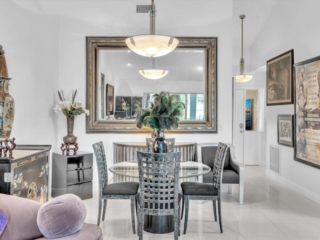 tiled dining room featuring lofted ceiling