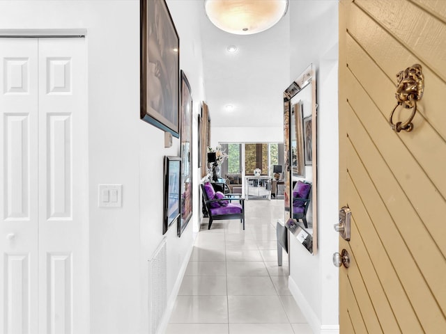 hall with light tile patterned floors