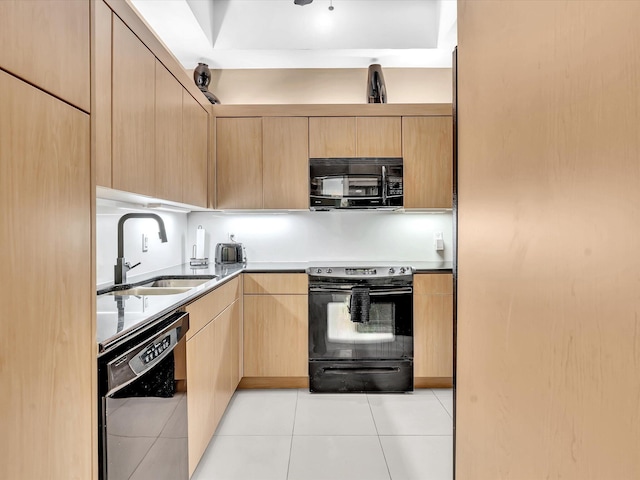 kitchen with light brown cabinetry, sink, black appliances, and light tile patterned flooring