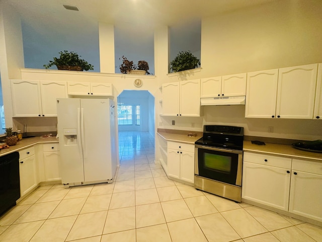 kitchen featuring dishwasher, white fridge with ice dispenser, stainless steel electric stove, white cabinetry, and a towering ceiling