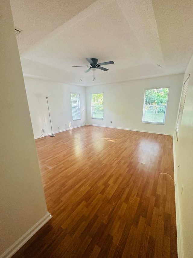 spare room featuring ceiling fan, a textured ceiling, and hardwood / wood-style floors