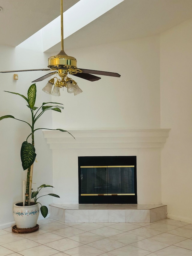 details with ceiling fan, tile patterned flooring, and a fireplace