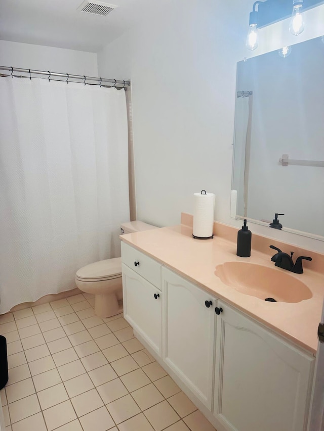 bathroom with vanity, toilet, a shower with shower curtain, and tile patterned flooring