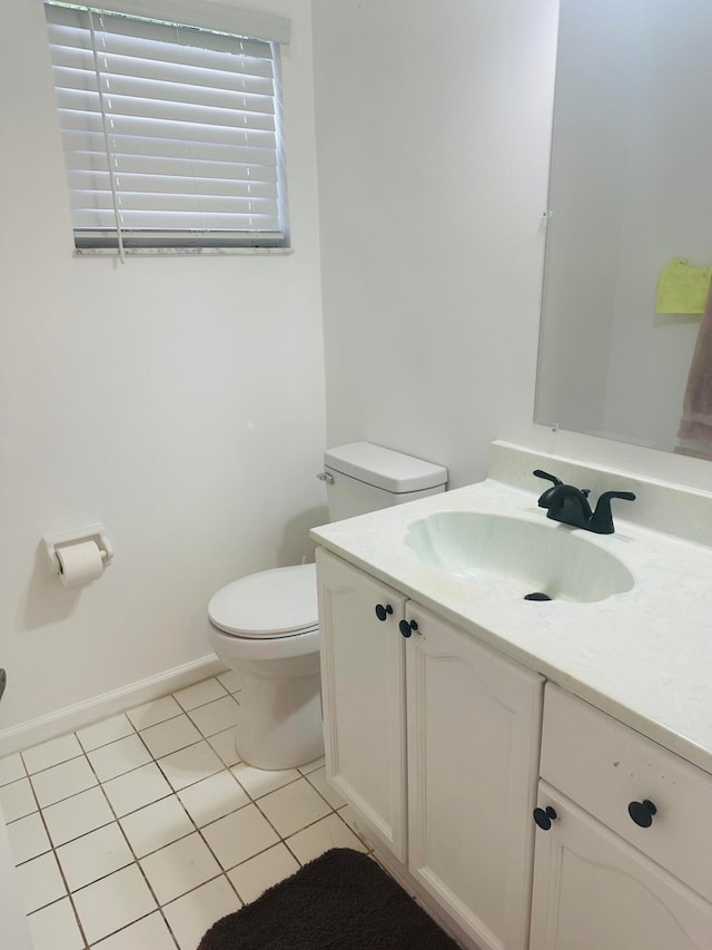 bathroom with vanity, toilet, and tile patterned floors