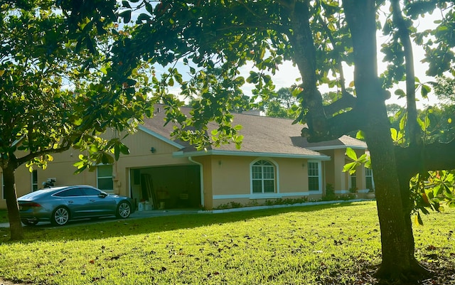 single story home with a front yard and a garage