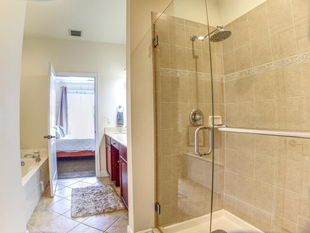 bathroom featuring vanity, tile patterned floors, and independent shower and bath