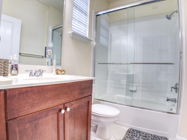 full bathroom featuring vanity, toilet, tile patterned floors, and enclosed tub / shower combo