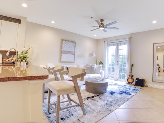 tiled living room with sink, french doors, and ceiling fan