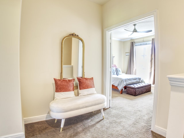 living area with ornamental molding and carpet floors