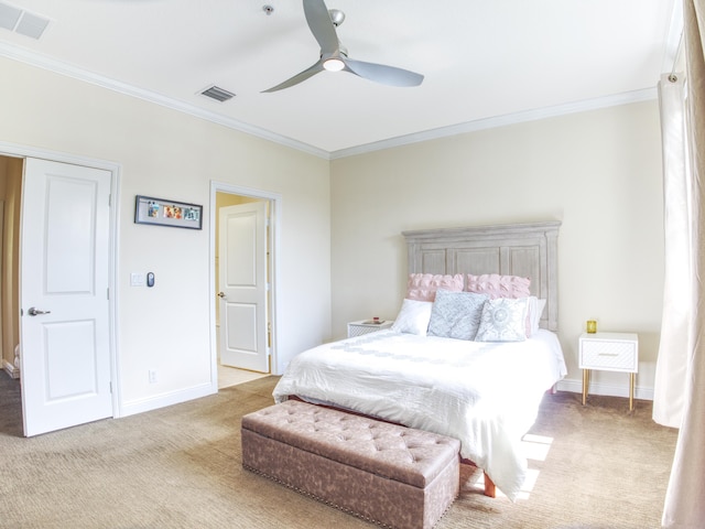 bedroom featuring ornamental molding, light colored carpet, and ceiling fan