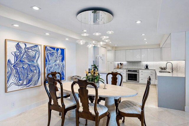 tiled dining room featuring sink