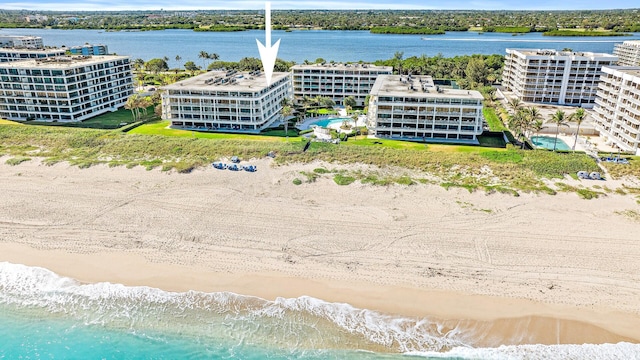 drone / aerial view with a water view and a beach view