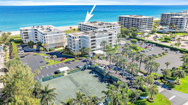 birds eye view of property featuring a view of the beach and a water view