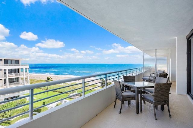 balcony featuring a water view and a beach view