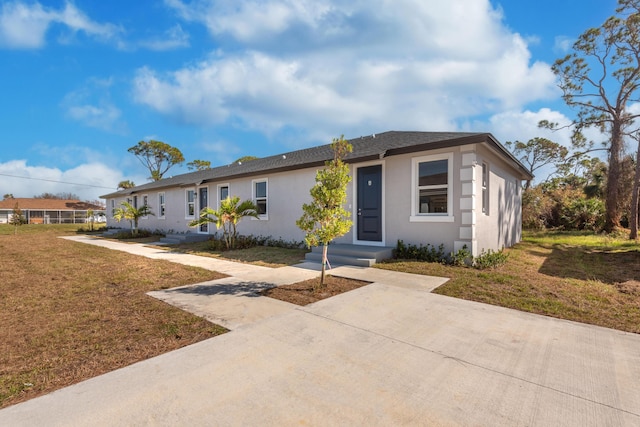 single story home with a front lawn and stucco siding