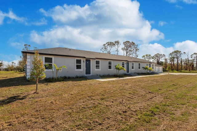 view of front facade with stucco siding and a front lawn