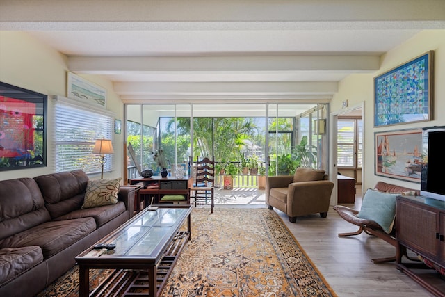 living room with beam ceiling and light hardwood / wood-style floors