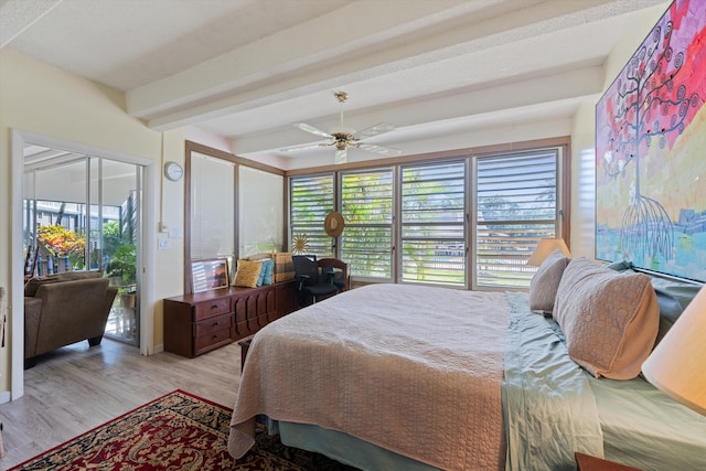 bedroom featuring access to outside, ceiling fan, light hardwood / wood-style flooring, and beamed ceiling