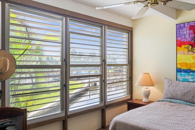 bedroom featuring ceiling fan and multiple windows