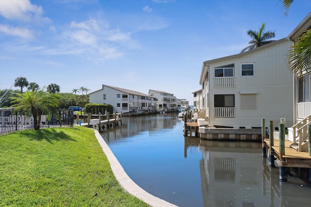 dock area featuring a water view and a yard