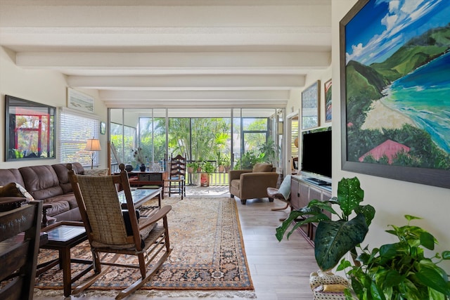 living room featuring beamed ceiling and light wood-type flooring