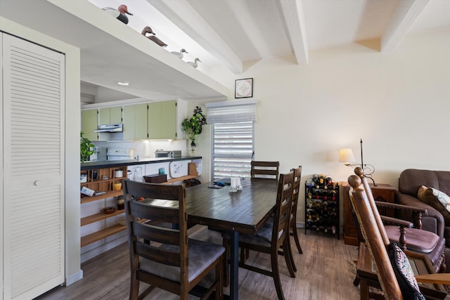 dining area featuring beam ceiling and dark wood-type flooring