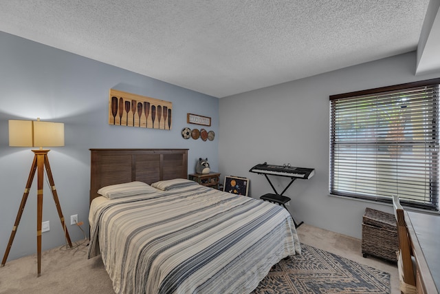 bedroom featuring light carpet and a textured ceiling