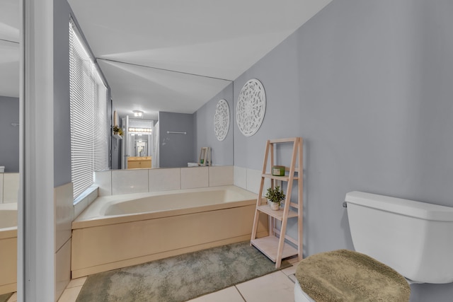 bathroom featuring toilet, a bathing tub, and tile patterned floors