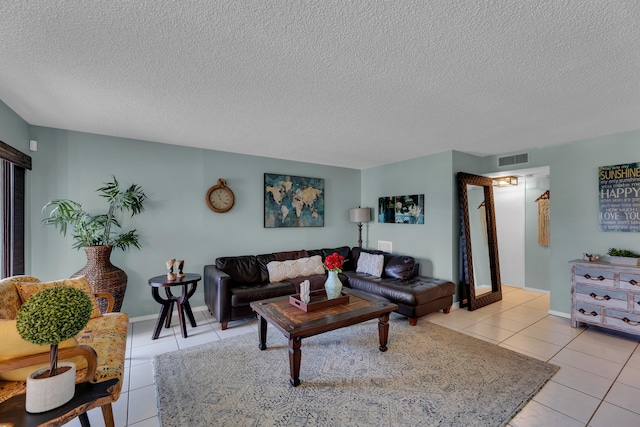 living room featuring a textured ceiling and light tile patterned flooring