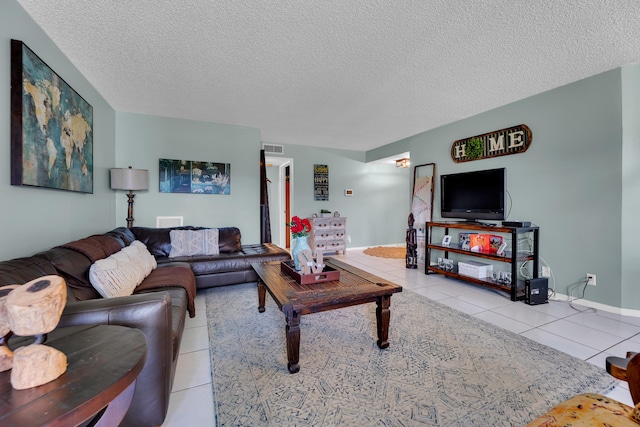 tiled living room featuring a textured ceiling