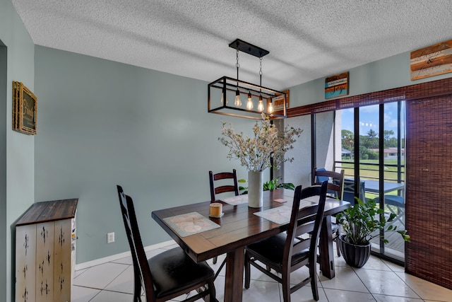 dining room featuring a textured ceiling and light tile patterned flooring